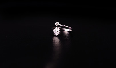 Fine silver jewelry on a black background with copy space