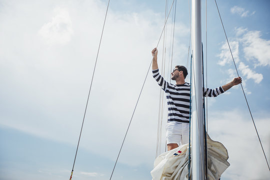 A Man Standing on Sailing Boat
