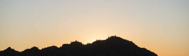 panoramic landscape image of cactuss covered hills in Argentina at sunrise