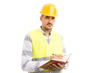 Smart successful engineer or builder holding agenda and writing.