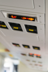 backlit sign of fasten seatbelt seat belt and no smoking on an airplane