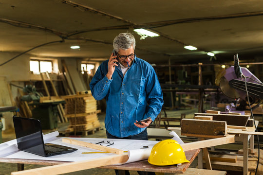 middle aged carpenter working in his workshop