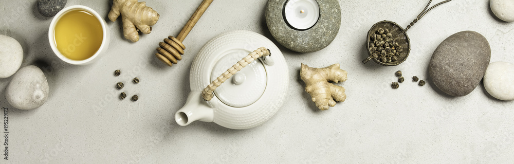 Wall mural Asian tea set and spa stones on concrete background