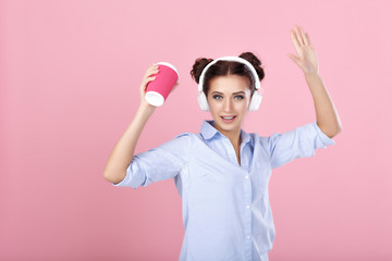 woman in headphones drinking coffee
