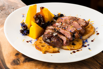 Duck breasts with sour plum - mango sauce, sweet potatoes and lotus