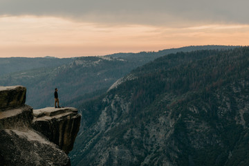 Man Standing at The Edge of A Mountain Cliff in Yosemite