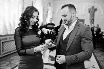 Marriage of cute couple. Putting rings on finger.