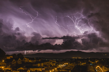 The furious lightning falling next to a quiet town. Magical lights and colours from the thunder and...