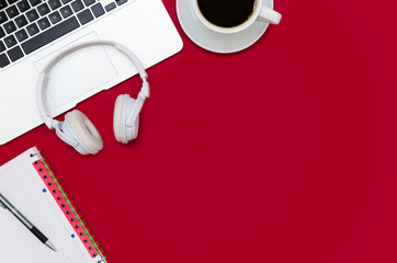 Office desk table with laptop, smartphone, and cup of coffee