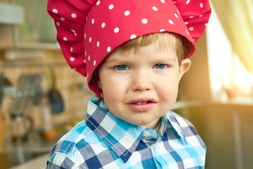 Toddler in chef hat. Adorable little boy.