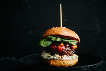 Burgers with grilled beef patties, cream cheese and spinach on classical bun.