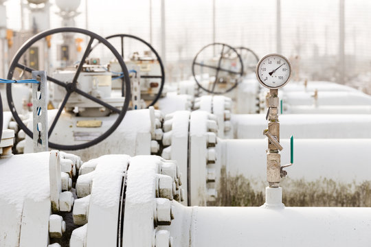 High Pressure Natural Gas Transport Installation In Cold Winter With Snow On The Gas Pipelines. High Pressure Manometer And Valve To Measure And Secure Gas Transport. 