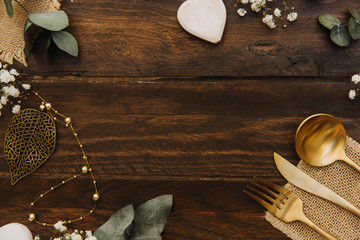 Flat lay composition with boho wedding decorations over wooden background. Top view, copy space