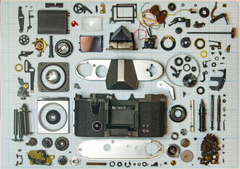 parts old retro film SLR camera on graph paper