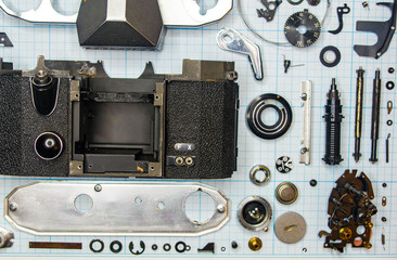 parts old retro film SLR camera on graph paper