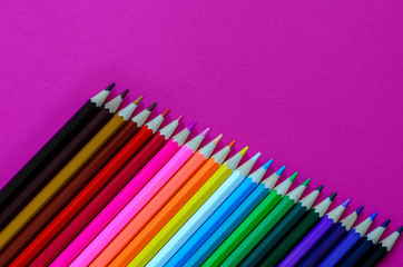 colored wooden pencils lined at the bottom left to right by the diagonal, above the space for text