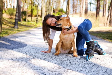 Outdoors lifestyle portrait of a beautiful girl wearing roller s