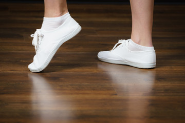 Woman wearing white bright sneakers trainers