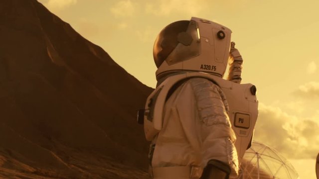 Following Shot of the Astronaut On Mars Walking Toward His Base/ Research Station, Looking Around. Shot on RED EPIC-W 8K Helium Cinema Camera.