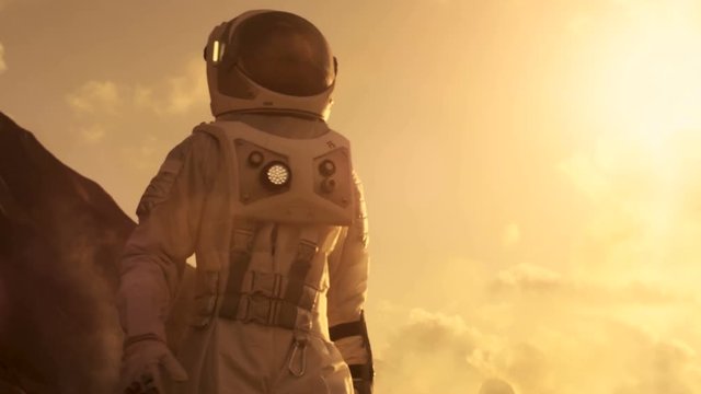 Middle Shot of the Astronaut Wearing Space Suit Exploring Mars/ Red Planet. First Manned Mission To Mars, Technological Advance Brings Space Exploration, Colonization. 