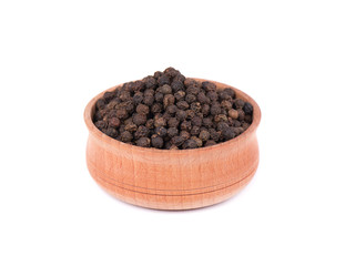 Black peppercorns isolated on white background. Peppercorn in a wooden bowl isolated on white.