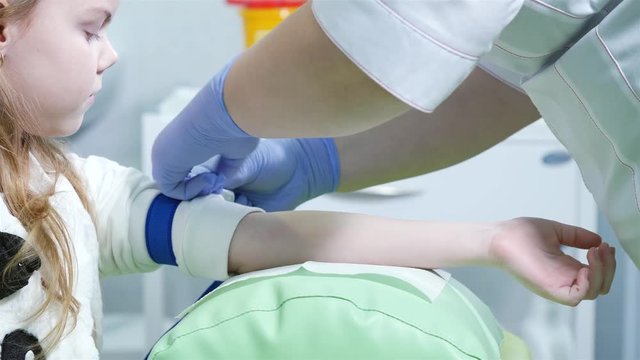 nurse makes blood sampling from a child