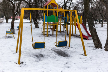 Old empty children playground in winter time