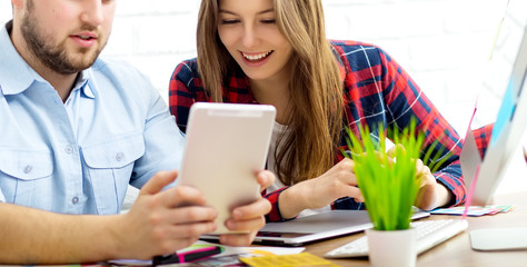Team of creative designers working on a common project in a design studio