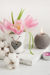 Fototapeta na wymiar Pink tulip flowers, lit candles