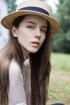 Portrait of a beautiful young girl in a hat