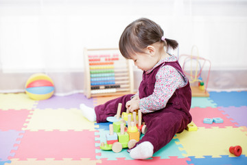 baby girl play toy blocks at home