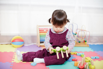 baby girl play toy blocks at home