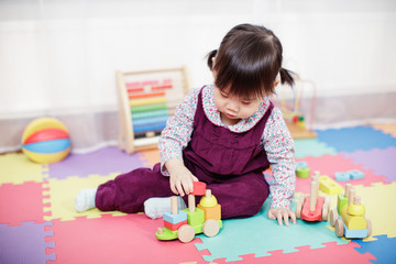 baby girl play toy blocks at home