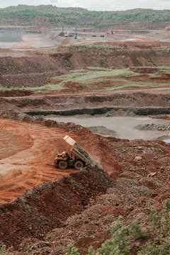 Huge truck dumping a load of rocks