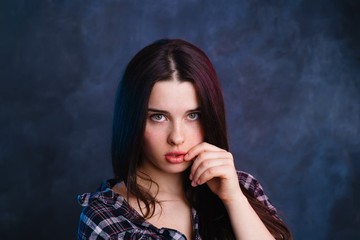 Young pretty woman with healthy skin and hair in checkered shirt studio shoot, copy space