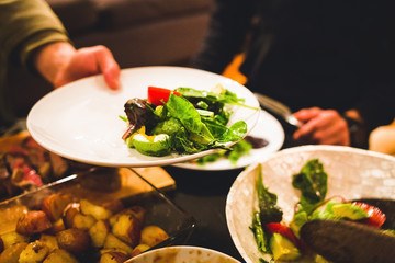 Healthy salad and meats dinner table