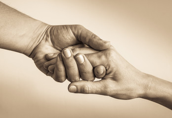 Closeup of hand helping hand.  Helping someone in need concept. 