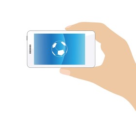 Ballon de foot dans un téléphone mobile tenu en main