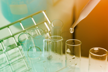 Dropping chemical liquid to test tube, laboratory research and development concept. scientist sample chemistry or medicine test
