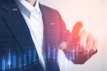 Future of financial business concept,Businessman touching increasing graph with finance symbols coming.