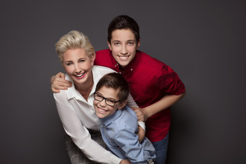 Happy mother posing with two sons.
