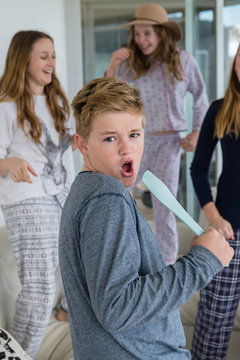 young teens being silly singing and dancing at home