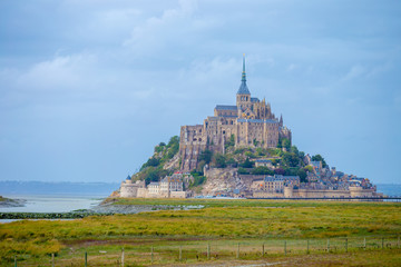 Amazing Mont Saint Michel cathedral on the island, Normandy, Northern France, Europe. Grey day