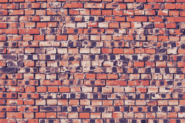 Obsolete brick wall with black stains