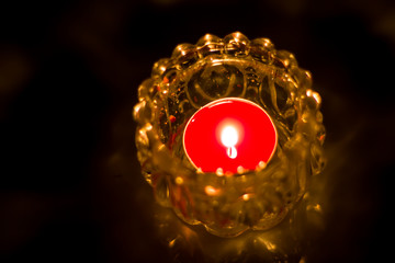 Closeup shot of Candle in white Jar on dark background
