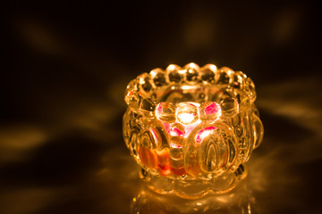 Closeup shot of Candle in white Jar on dark background