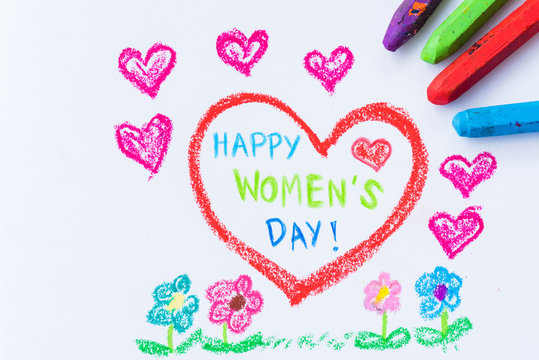 Pencil color drawing Happy Women's Day on white paper with paper star. Womens Day concept.