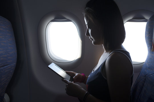 One Young Asian Woman Reading Book In The Plane