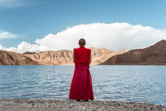 Buddhist monk from the back looking to the lake