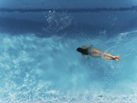 Aerial Shoot Of Woman In Swimming Pool.